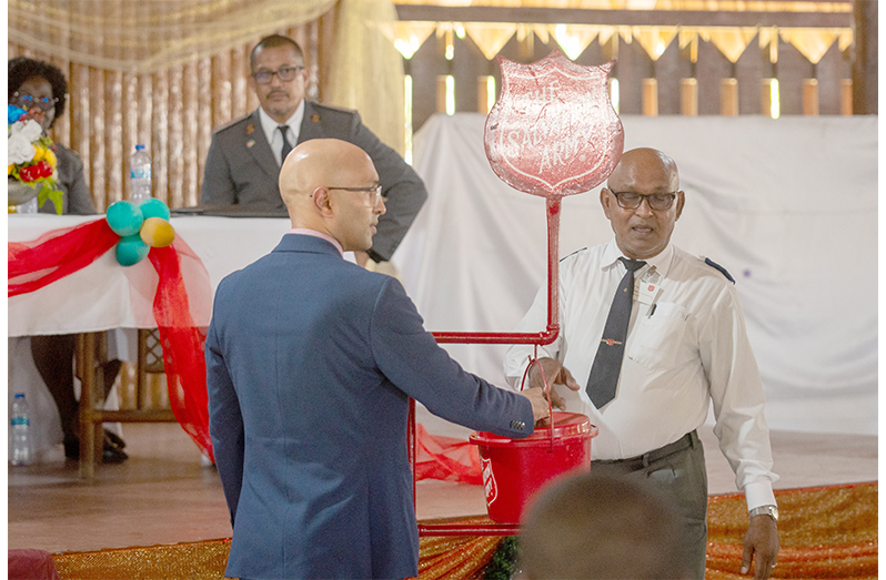 Kettle 1 Nicholas Boyer makes the first donation as part of the Salvation Army’s Christmas appeal (Delano Williams photos)