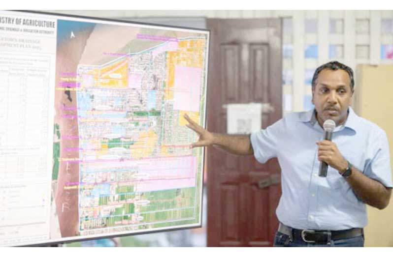 Chairman of the National Drainage and Irrigation Authority, Lionel Wordsworth, explains the detailed plan for the Georgetown Drainage Improvement Project. [DPI Photos]