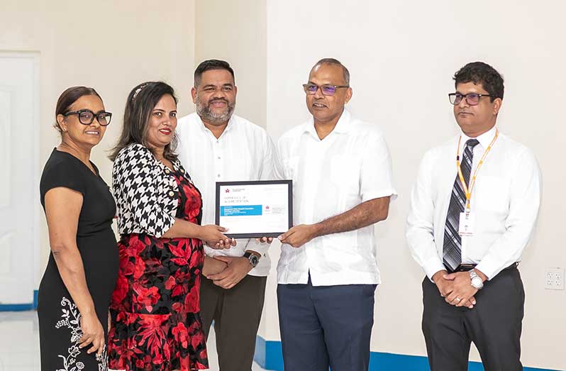 From left: Head of Laboratory Services, Dr. Pheona Mohamed-Rambarran; Pathology Laboratory Manager, Maricea Comacho; GPHC CEO, Robbie Rambarran; Minister of Health, Dr. Frank Anthony and Head of General Surgeries, Dr. Navindranuth Rambarran with the ISO Certification during the ceremony (Delano Williams photos)