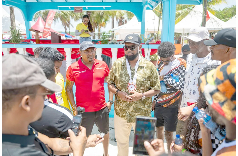 President Irfaan Ali interacting with racers at the Lake Mainstay Regatta held recently (DPI photo)