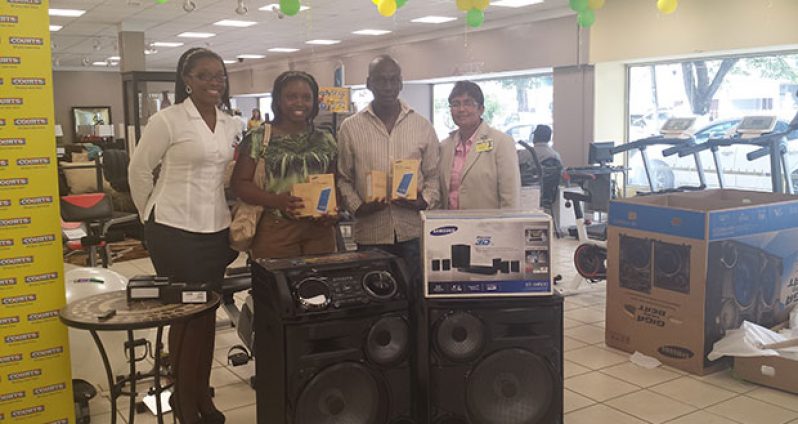 Courts Guyana representatives present prizes to some of the winners.