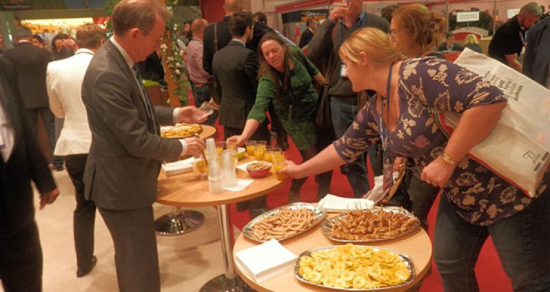 Visitors at the Guyana Booth sample some of our  cuisine