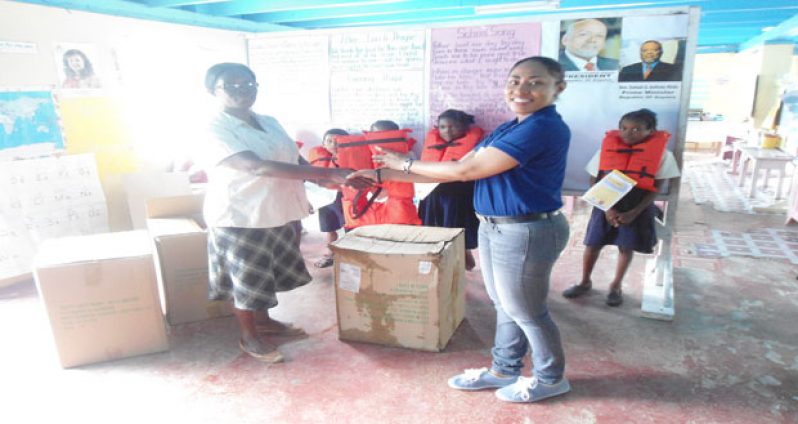 MARAD's Public Communications Officer handing lifejackets over to Lilydale Primary School.