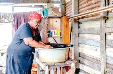 Joycelyn Charles washing at her home