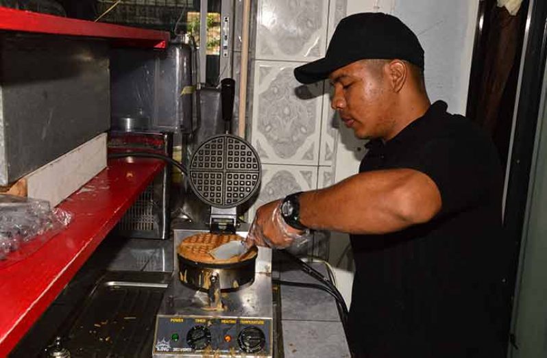 An employee making a fresh batch of waffles (Photos by Adrian Narine)