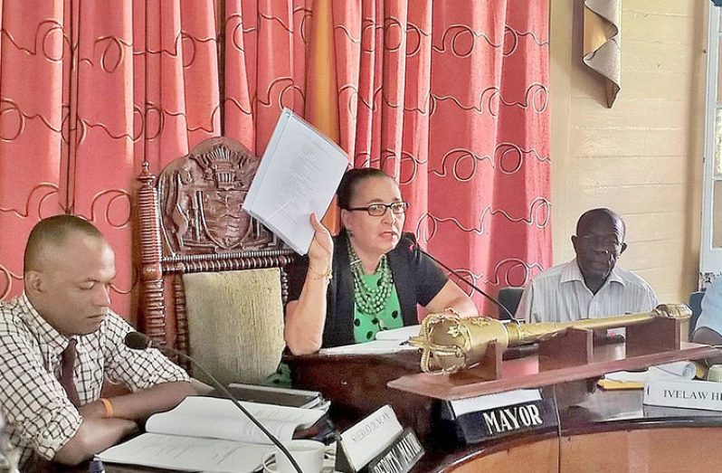 Signed! Mayor Patricia Chase-Green shows councillors the by-laws document that was signed on Monday by Communities Minister Ronald Bulkan (Photo by Telesha Ramnarine)