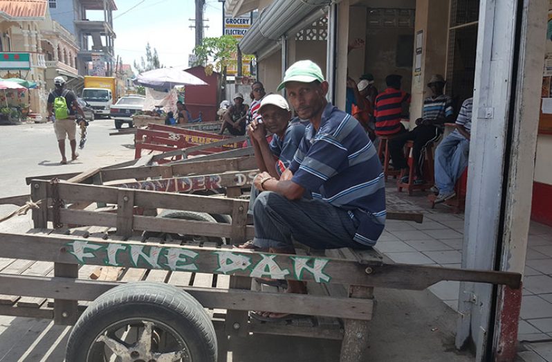 Amarnauth Latchman and Balgobin liming at Parika Junction on their push-carts awaiting customers