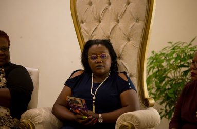 Minister Simona Broomes listening attentively to presenters at the surprise thanksgiving ceremony