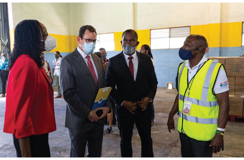 CDEMA Logistics Specialist, Major Curtis Dennie (at right) discusses the plan for distribution with (from left) CDEMA Executive Director (ag.) Elizabeth Riley, CDB President Dr. Warren Smith and Barbados’ Minister of Maritime Affairs and the Blue Economy, Hon. Kirk Humphrey