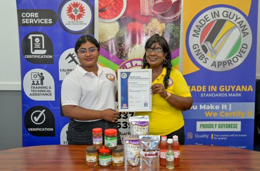 1.	Owner and CEO of B&R Products, Budwatty Ramnarine and her daughter Adelia Ramnarine proudly display GNBS Approved Made in Guyana Certificate alongside the certified products.