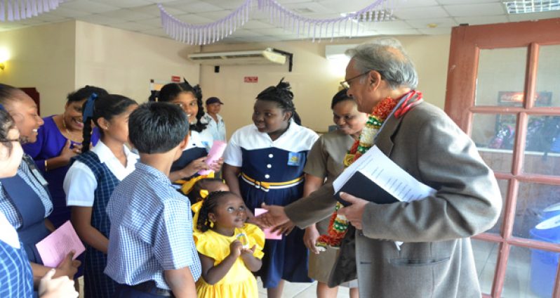 Education Minister Dr. Rupert Roopnaraine interacting with children at the launch of Education Month yesterday
