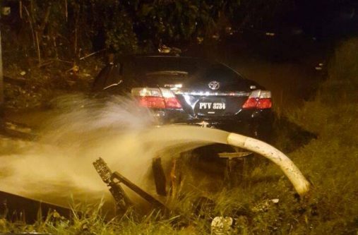 The speeding car was partially submerged in the trench. It had crashed into a water main before coming to a stop