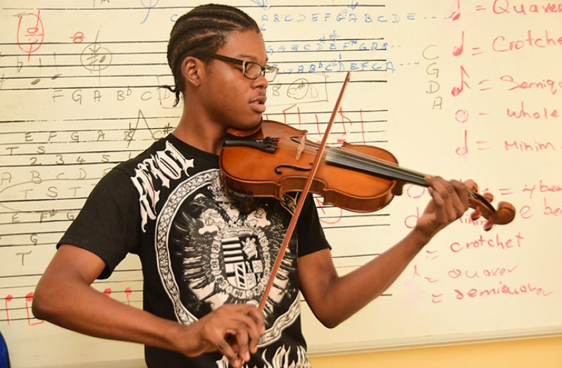 Mr. Akeem Adams enjoying one of his favourite  pieces  (Photos by Adrian Narine)