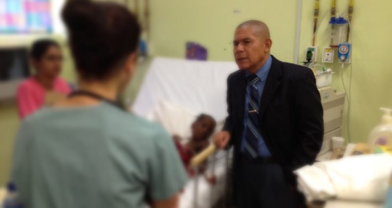 Dr Norton speaks with one of the team members of the Baby Heart Foundation