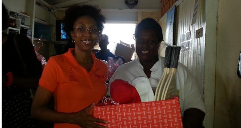 Digicel Guyana Head of Marketing, Ms Jacqueline James, as she made the presentation to Bridget Dundas yesterday at Dundas’s home.