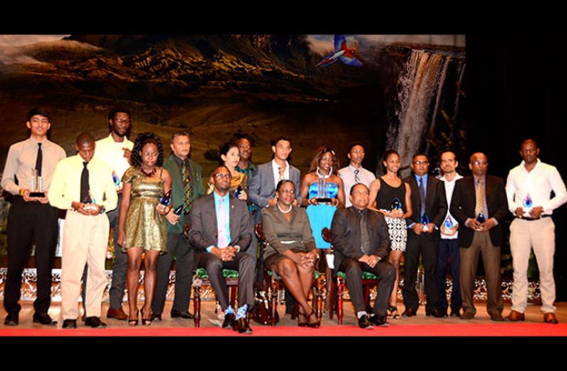 The various winners of the 2015 NSC Sport Awards flank Sport Director Christopher Jones and Junior Minister of Education Nicolette Henry. (Adrian Narine photo)