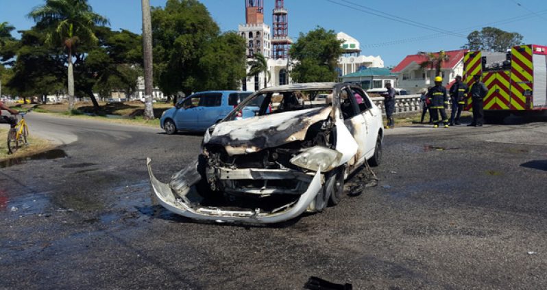 The burnt-out Corolla at the junction of North Road and New Garden Street following the accident (Photos by Michel Outridge)