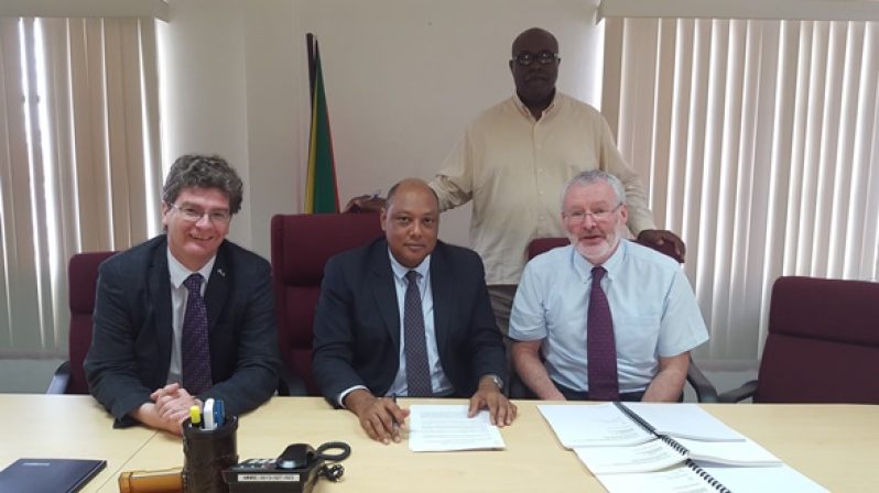 From left: British High Commissioner to Guyana, Mr. Greg Quinn, Minister of Natural Resources, Mr. Raphael Trotman and Mr. John McKenna of Tullow Oil prepare to sign a new prospecting license agreement. Mr. Newell Dennison, Acting Commissioner of the GGMC stands back, right.