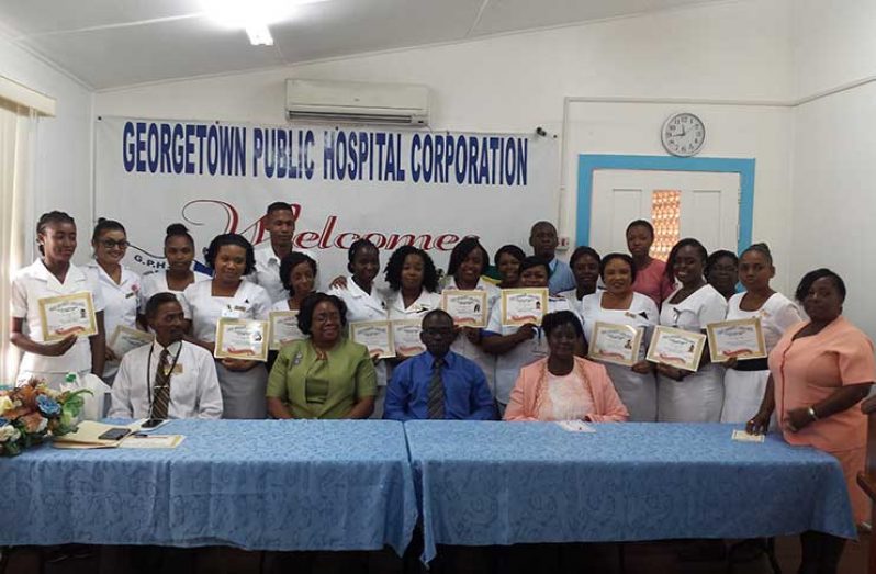 GPHC officials pose with the batch of nurses who completed training in Customer Care.  Seated from left:  Mr. Keith Alonza ADNS; Ms Celeste Gordon, ADNS; Brigadier George Lewis, CEO; Pastor Audrey Hinds, Facilitator.
