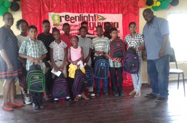 Salome Osborne (left) and Ryan Jaccob (right) with winners of the Greenlight Guyana Educational Inc. Awards 2018 at La Retraite Primary School.