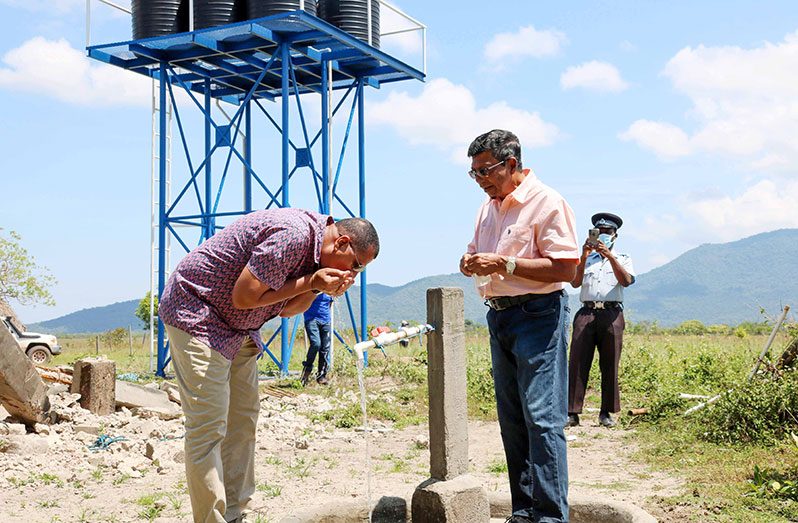Minister Croal sampling  water from the Parikawarinau well