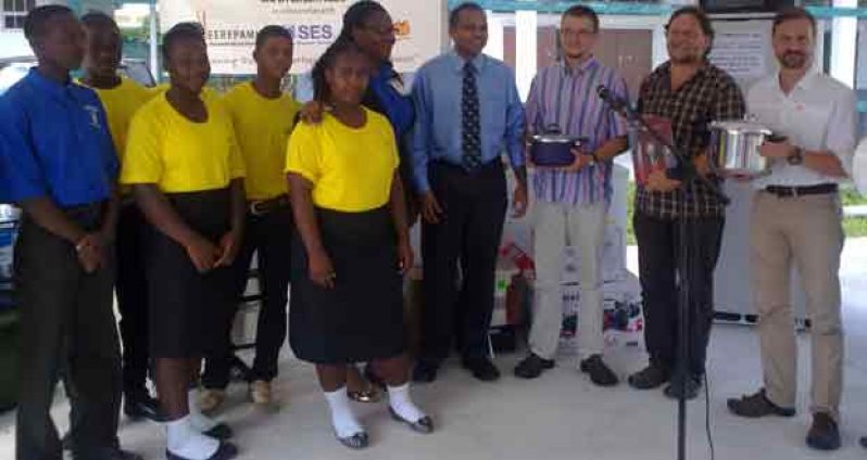 Robert Spitzer of Eerepami (third from right), flanked by the representatives from the German companies, presents the equipment to Minister of Culture, Youth and Sport, Dr. Frank Anthony (fourth from right) and the students and staff of the New Opportunity Corps (NOC)