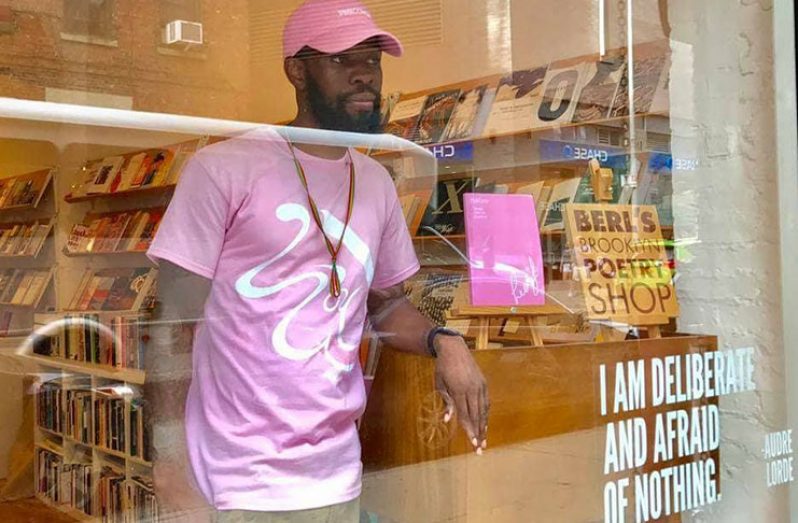 Guyanese author, Leon Labastide stands in a bookstore where his book ‘Pink Cover’ is being advertised.