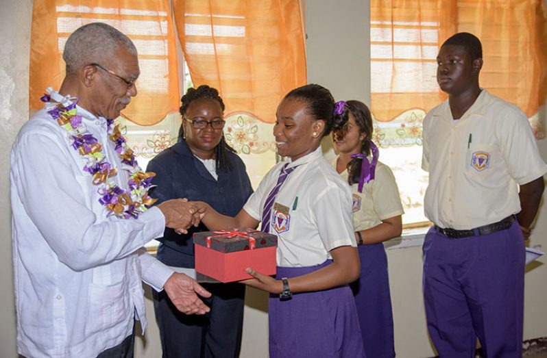 President Granger receives a token from  students of  the Modern Languages Department