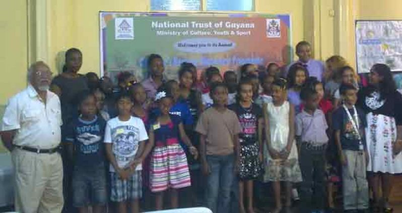 The participants of the National Trust Children’s Heritage Awareness Programme pose with the Minister of Culture, Youth and Sport, Dr. Frank Anthony (back row right), CEO of the National Trust of Guyana, Nirvana Persaud (front right); Chairman of the National Trust of Guyana, Lennox Hernandez (left); and the teachers involved in the programme