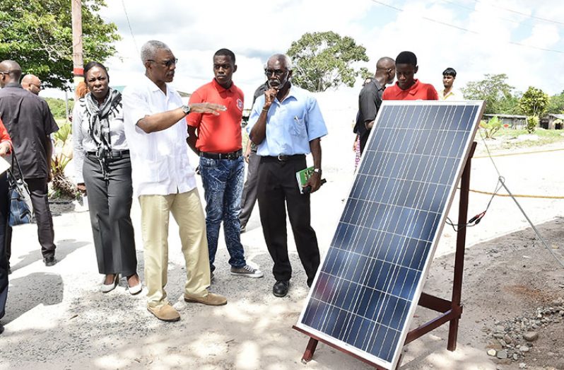 President David Granger urged students and staff of the Kuru Kuru Training Centre to develop their capacity to harness power from renewable sources of energy. In this photo, he takes a look at a solar panel, which was used by the electrical installation class to power a lighting system