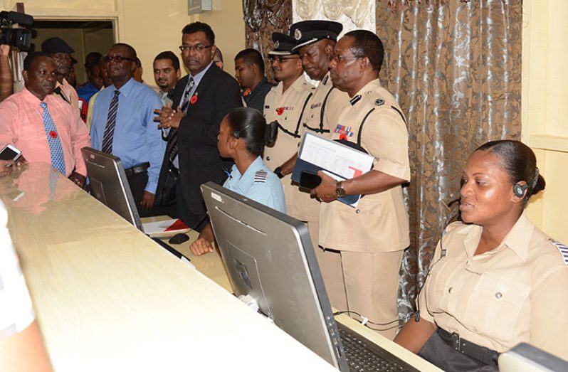 Public Security Minister Khemraj Ramjattan flanked by senior officers of the Guyana Police Force during a tour of the long-awaited 911 emergency system (Rabindra Rooplall photo)