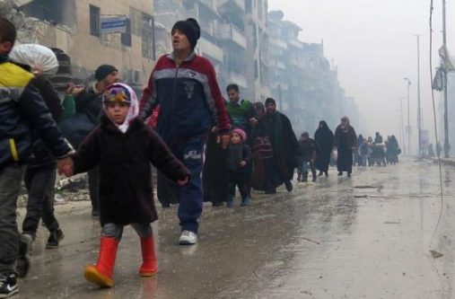 A stream of people try to flee the fighting