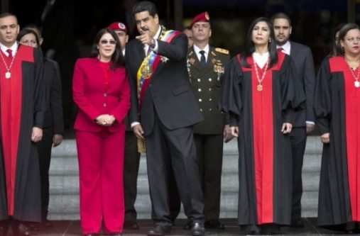 Nicolas Maduro speaks to first lady Cilia Flores next to Supreme Court judges