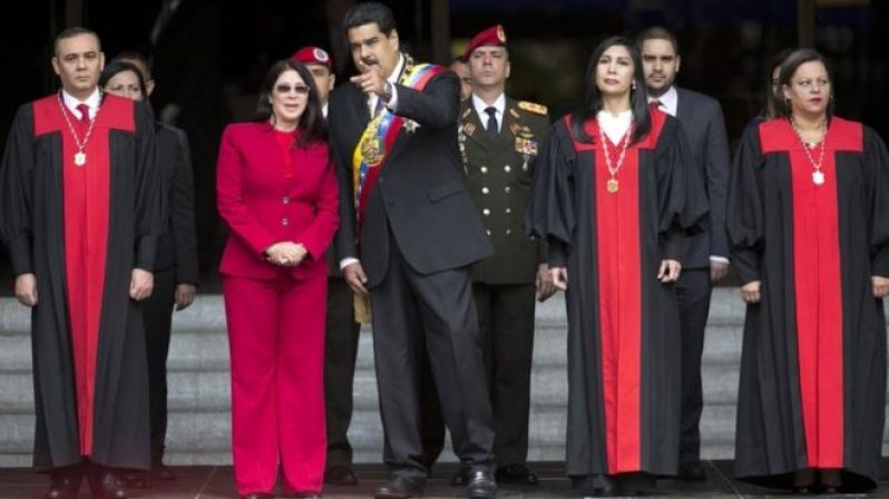 Nicolas Maduro speaks to first lady Cilia Flores next to Supreme Court judges