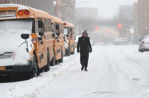 A man walks through the snow in New York City on Tuesday