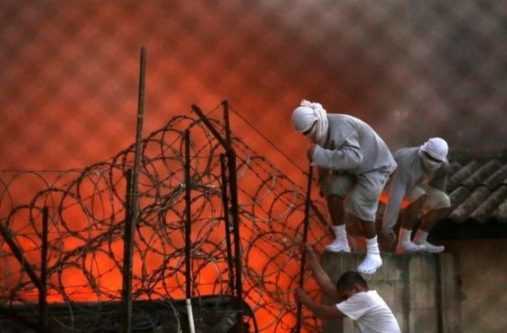 Inmates climbed the roof of the detention centre as others set mattresses alight