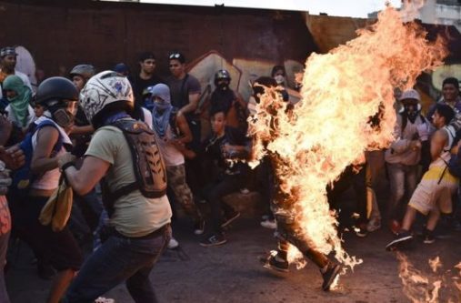 Orlando José Figuera was seen engulfed in flames