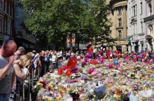 Flowers and tributes lined St Ann's Square in Manchester on Monday