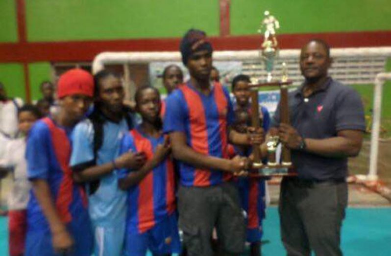 Tiger Bay team receive their trophy from Superintendent Phillip Azore.