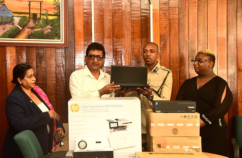 Attorney-General and Minister of Legal Affairs Anil Nandlall handing over some of the ICT equipment to the Director of the GPS, Nicklon Elliot (Adrian Narine photo)