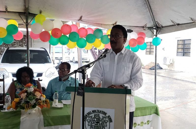 Attorney General (AG) and Minister of the Legal Affairs, Basil Williams addressing the gathering. Also at the table are: Chairman of Region Four, Genevieve Allen and Vice Chairman, Earl Lambert at the head table