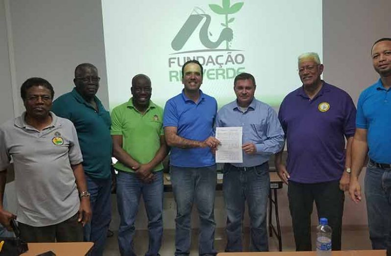 President of NF Agriculture Inc. Yucatan Reis and President of the Rio Verde Research Foundation Marino Franz, hold the signed MOU. Also in photo are Agriculture Minister Noel Holder (second right) and GO-INVEST’s Chief Executive Officer (CEO) Owen Verwey (right)