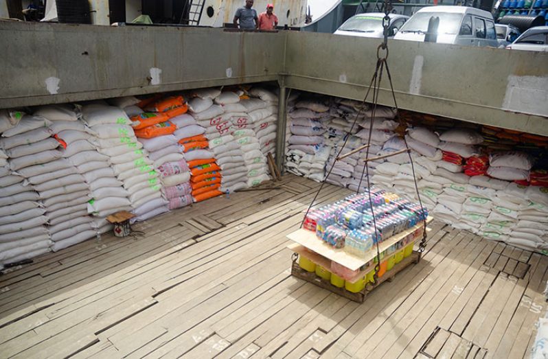 Goods being loaded into the hull of the ship before it sets sail.