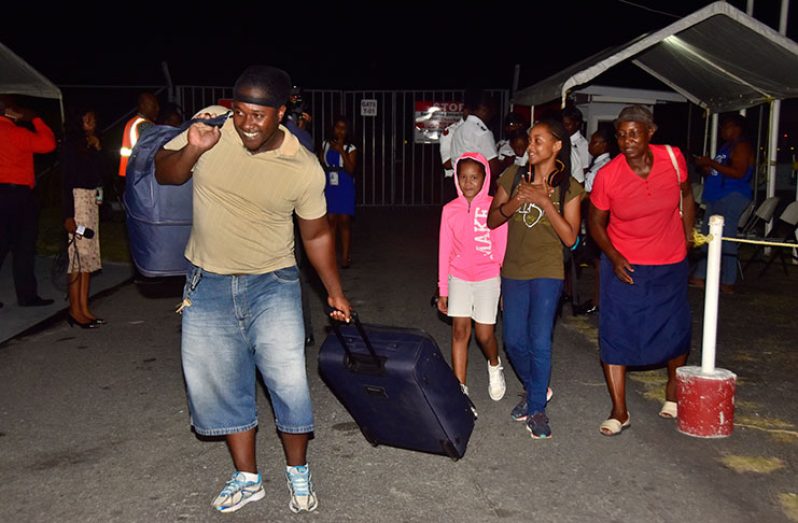 The look on their faces says it all as
the evacuees touched down at the Ogle
International Airport on Monday evening
(Photo by Adrian Narine)