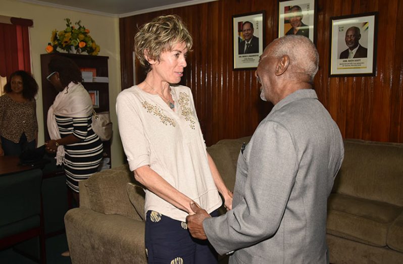 Minister Keith Scott and ILO Director, Claudia Coenjaerts, greeting each other upon her arrival on Thursday at his Brickdam office for a meeting.