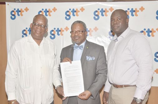 Following the signing Monday of the landmark GTT-UG deal, are, from left: Minister of Finance, Mr Winston Jordan;  Vice-Chancellor, Dr Ivelaw Griffith and Mr Justin Nedd