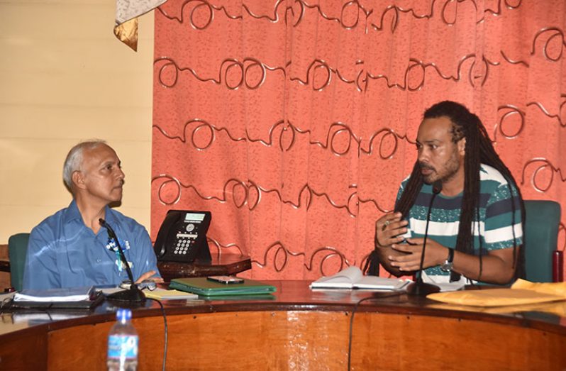 Minister of Communities Ronald Bulkan speaking to Councillor Malcolm Ferreira during the discussion on Thursday