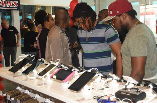 Some of the first customers of Radio Shack Guyana store examine a range of IPADs at the store at Giftland Mall, Turkeyen Friday (Adrian Narine photograph)