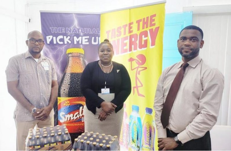 Business Unit Head for Non-Alcoholic Beverages, Errol Nelson (extreme right) after handing over non-alcoholic beverages to GPHC representatives. (ANSA McAL photo)