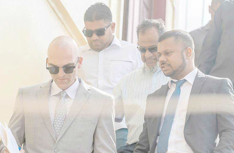 Nazar and Azruddin Mohamed with their attorneys, Siand Dhurjon and Damien DaSilva at the Georgetown Magistrates’ Court (Delano Williams photo)